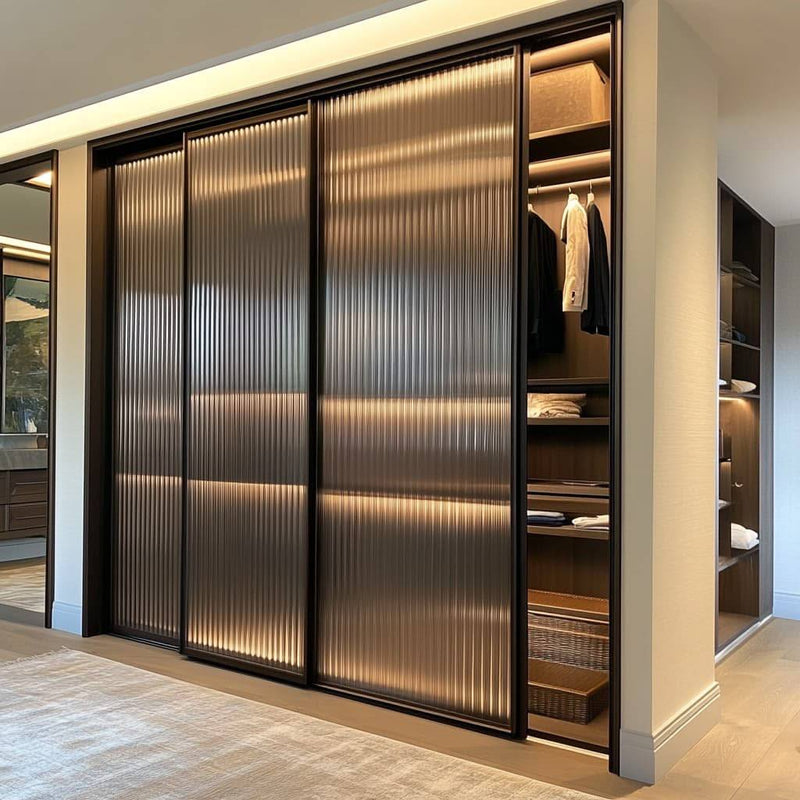Fluted glass sliding wardrobe with integrated lighting